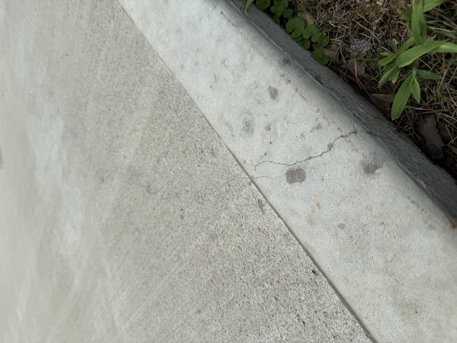 Crack at the edge of a driveway pad