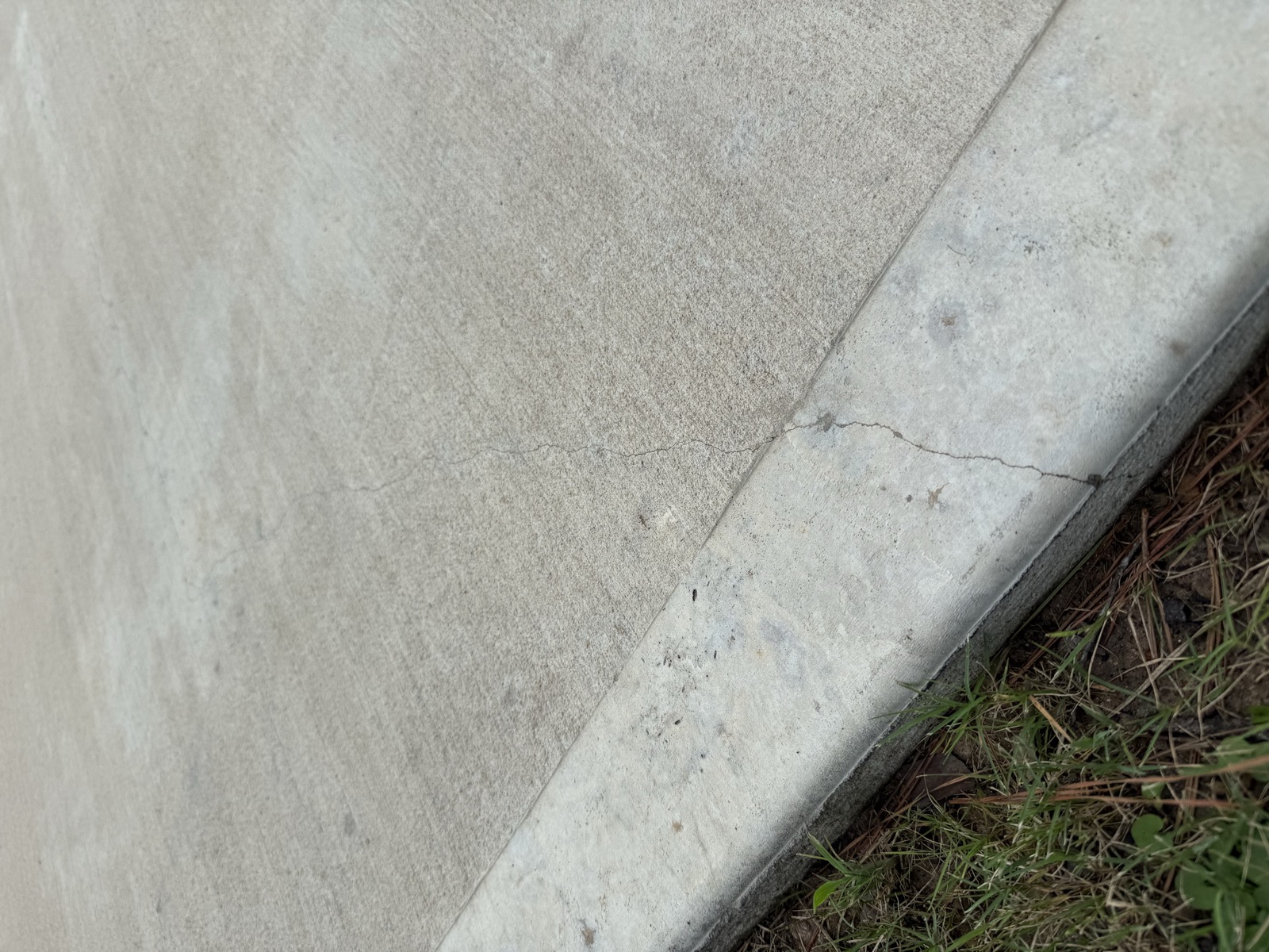 Crack running across a driveway joint