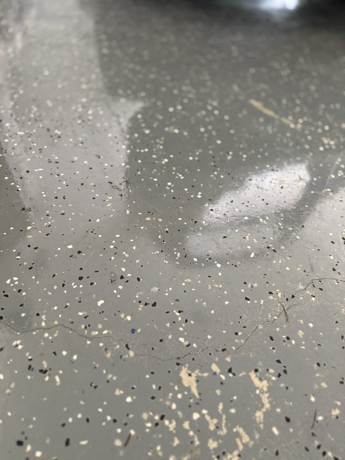 Crack through the slab under the peeling epoxy floor