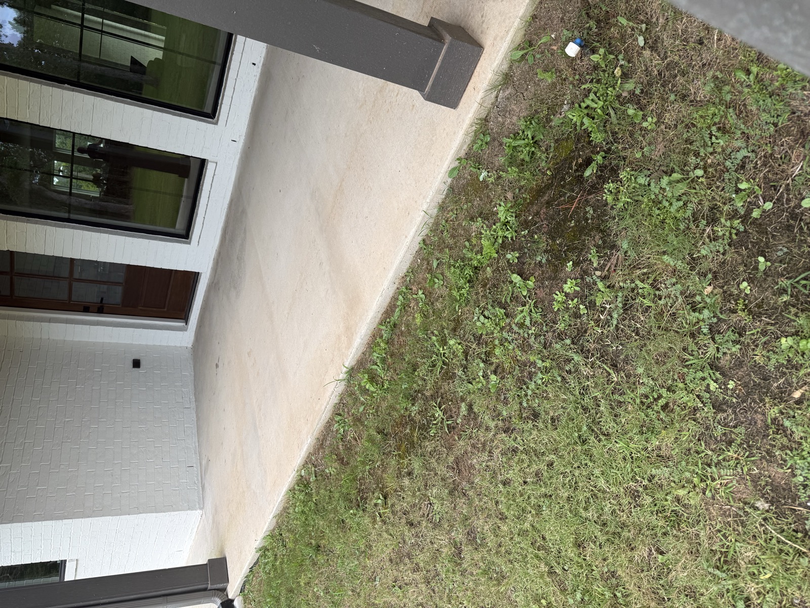 Eroded bare soil along the foundation