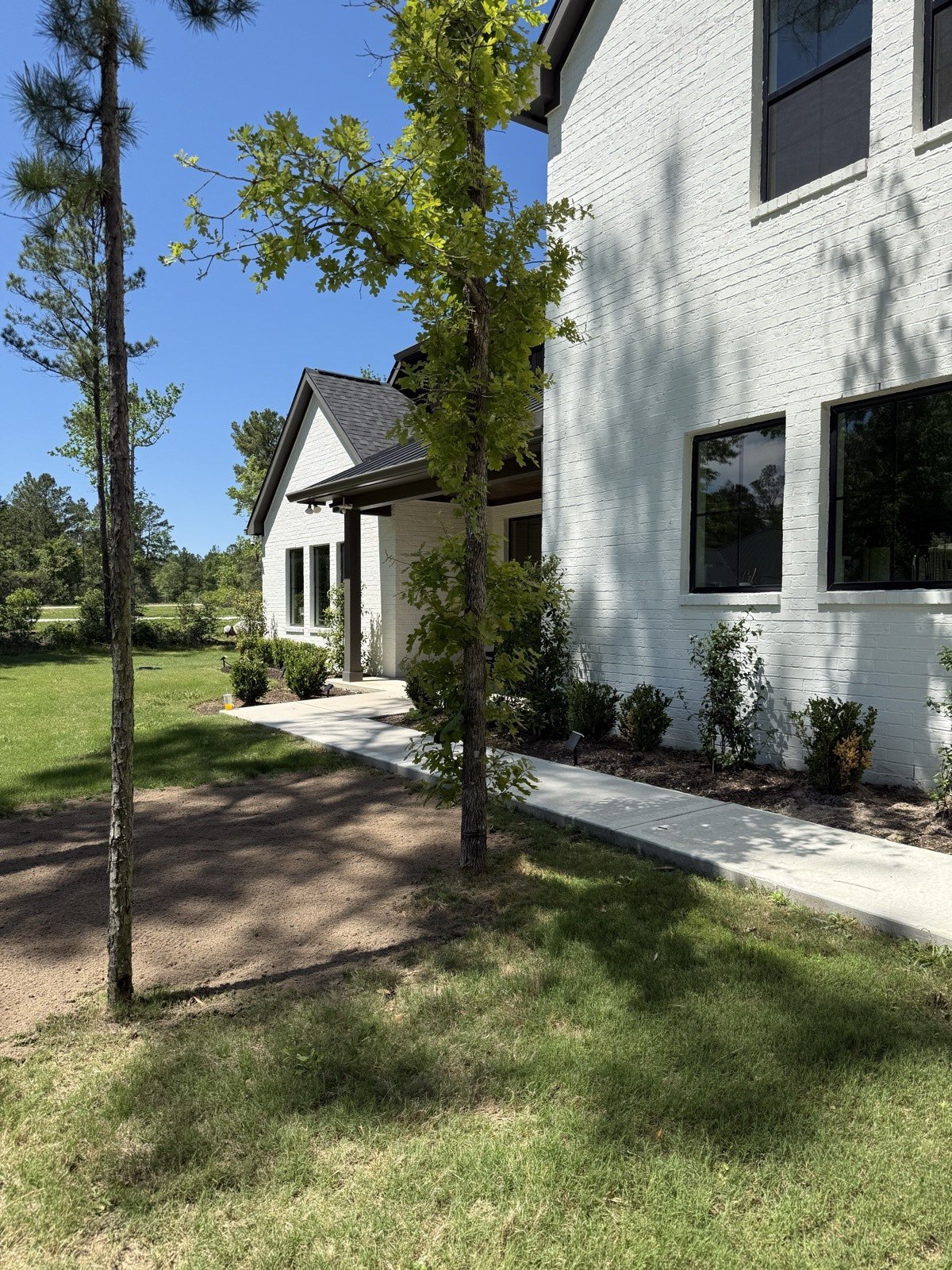 7610 Trinity Pines Drive — our custom white-brick home in High Meadow Estates, Montgomery, TX, set among tall pines