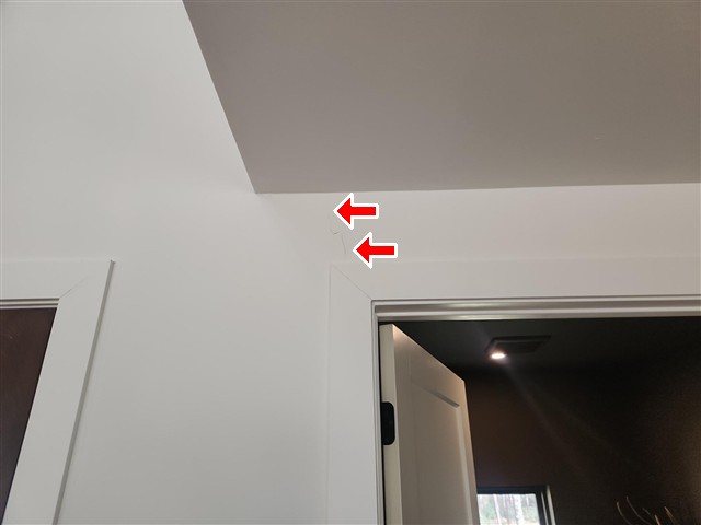 Drywall crack above the powder-room door