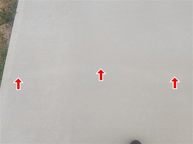 Two driveway pads cracked across the entire pad
